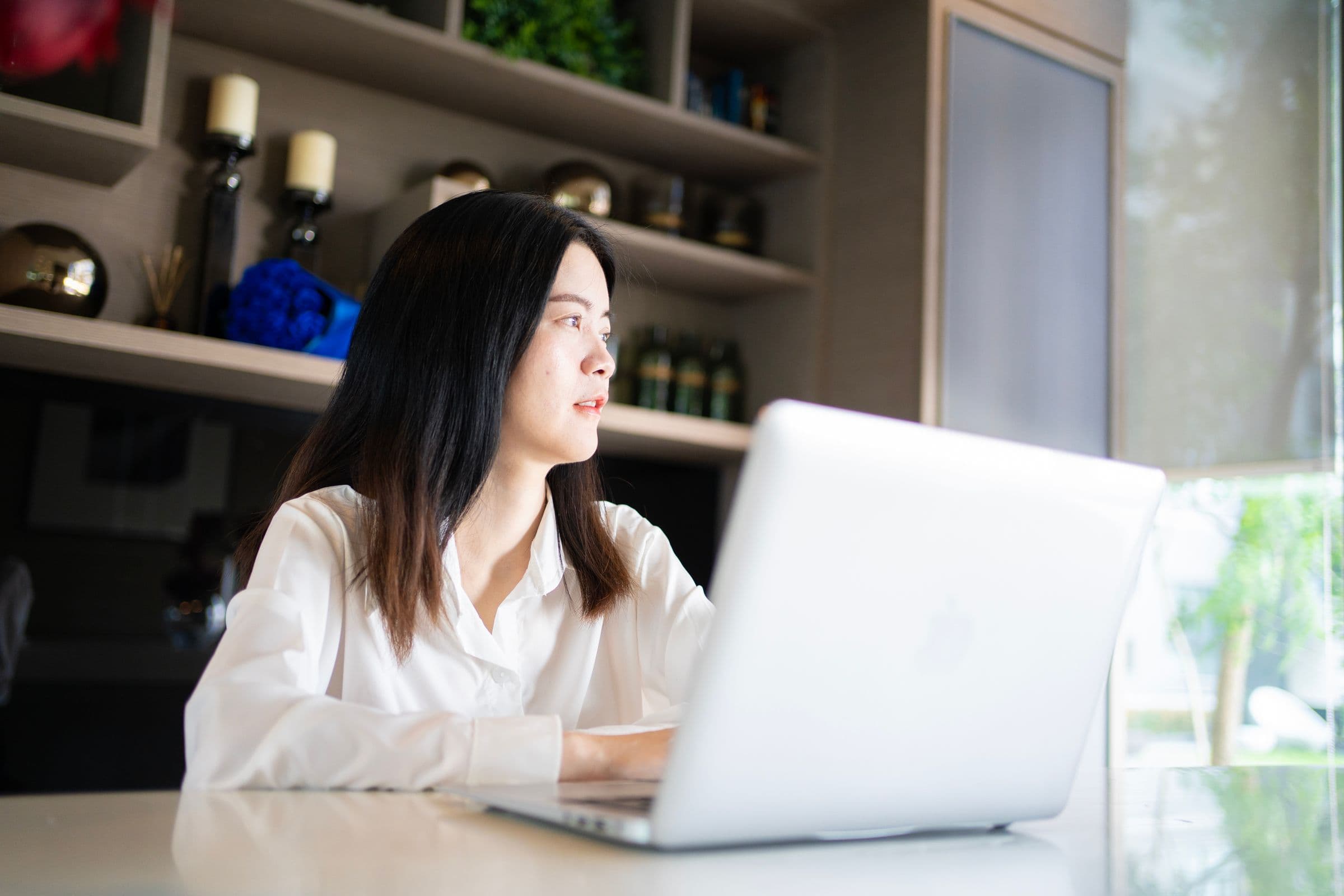 Founder working on her laptop in a bright home office